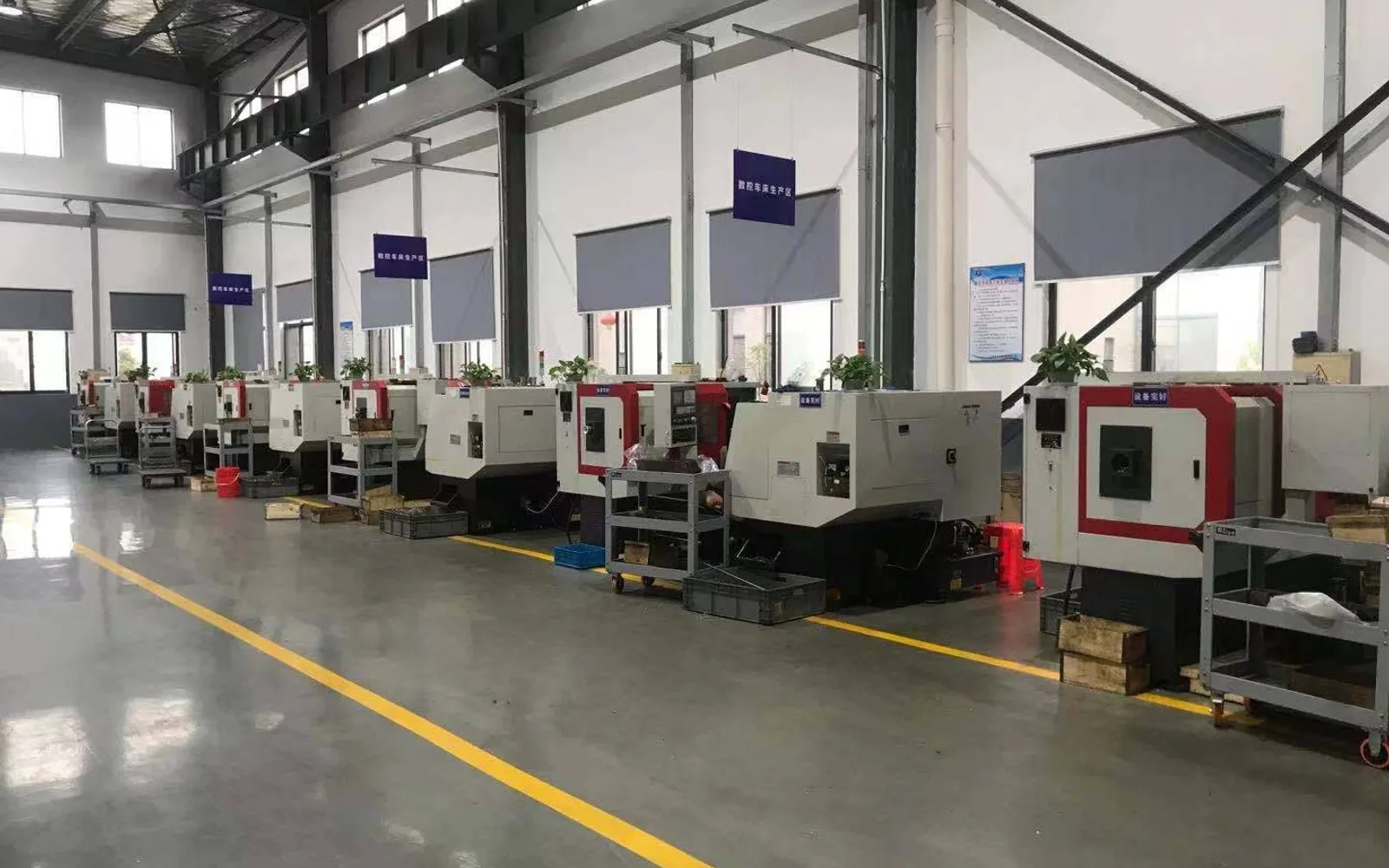 KEC Tour workshop with a row of CNC production machines